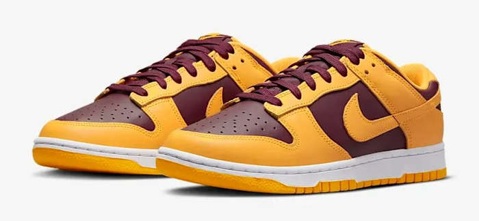 Side view of maroon and gold Nike Dunk shoes.